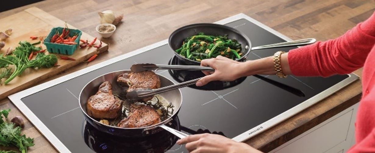 Person cooking food on induction cooktop