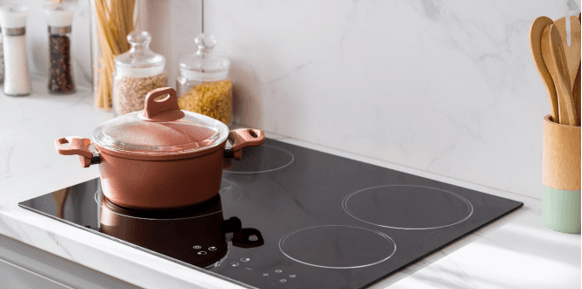 Induction Cooktop with pink pot and lid 