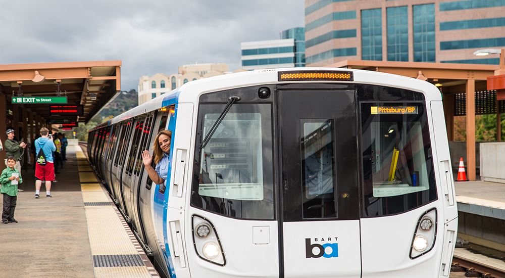 Woman waving from a bart train