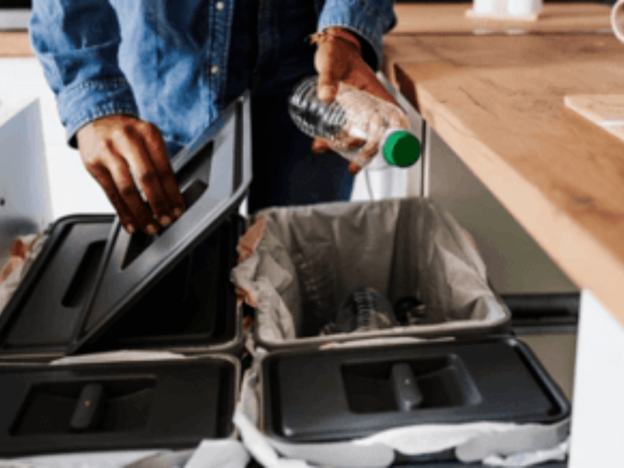 Man recycling plastic water bottle in his home