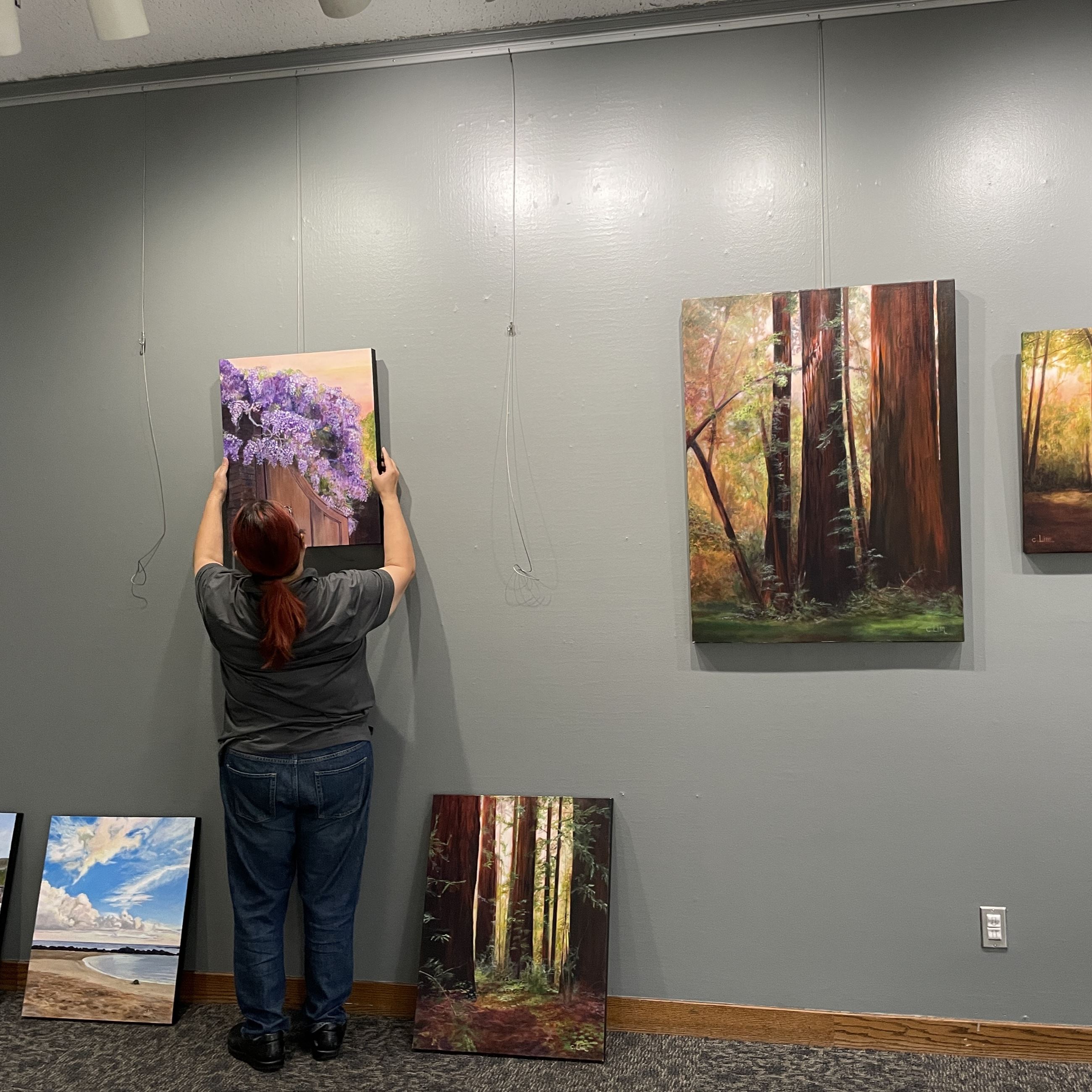 Artist Hanging a Painting